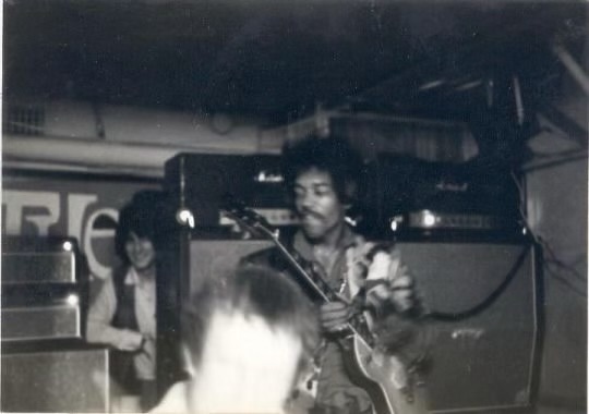 Ron Wood appears behind of Jimi Hendrix at The Scene